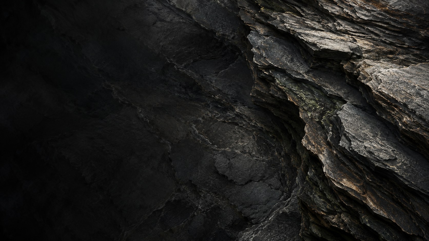 Abstract study of layered stone in charcoal and bronze tones